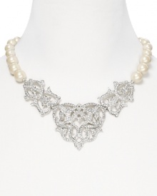An ornate crystal cluster is a glamorous focal point on this Carolee necklace, crafted of silver plated metal and pearly beads. An ornate crystal cluster is a glamorous focal point on this Carolee necklace, crafted of silver plated metal and pearly beads.