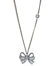 Take a bow. Betsey Johnson's silver tone mixed metal necklace features a sparkling bow pendant accented with clear and blue crystals, while a glass opal gem with crystal accents adorns the double silver tone chain. Approximate length: 32 inches + 3-inch extender. Approximate drop length: 1-3/4 inches. Approximate drop width: 2 inches. Take a bow. Betsey Johnson's silver tone mixed metal necklace features a sparkling bow pendant accented with clear and blue crystals, while a glass opal gem with crystal accents adorns the double silver tone chain. Approximate length: 32 inches + 3-inch extender. Approximate drop length: 1-3/4 inches. Approximate drop width: 2 inches.