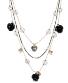 Love with a dark side. Betsey Johnson's illusion necklace features three layers of black glitter roses, crystal hearts, clear faceted beads, gold tone bubble hearts, small glass pearls and black tone chains. Crafted in antiqued gold tone mixed metal. Approximate length: 16 inches + 3-inch extender. Approximate drop: 3-1/2 inches. Love with a dark side. Betsey Johnson's illusion necklace features three layers of black glitter roses, crystal hearts, clear faceted beads, gold tone bubble hearts, small glass pearls and black tone chains. Crafted in antiqued gold tone mixed metal. Approximate length: 16 inches + 3-inch extender. Approximate drop: 3-1/2 inches.
