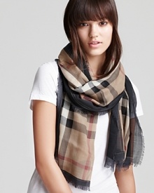 This signature Burberry scarf is the perfect way to tie up every look. This signature Burberry scarf is the perfect way to tie up every look.