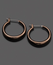 Fossil spices up traditional hoops with a chic ionic brown plating. Earrings crafted in mixed metal. Approximate diameter: 3/4 inches. Fossil spices up traditional hoops with a chic ionic brown plating. Earrings crafted in mixed metal. Approximate diameter: 3/4 inches.
