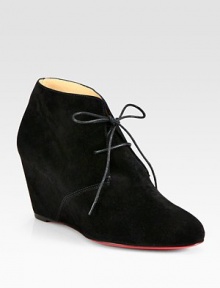 Trend-forward suede ankle boot has a lace-up front, self-covered wedge and signature red leather sole. Self-covered wedge, 3 (75mm)Suede upperLeather liningSignature red leather solePadded insoleMade in ItalyOUR FIT MODEL RECOMMENDS ordering one half size up as this style runs small. Trend-forward suede ankle boot has a lace-up front, self-covered wedge and signature red leather sole. Self-covered wedge, 3 (75mm)Suede upperLeather liningSignature red leather solePadded insoleMade in ItalyOUR FIT MODEL RECOMMENDS ordering one half size up as this style runs small.