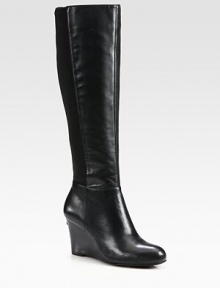 This sleek leather design is freshened with comfortable stretch paneling and a stacked wedge. Stacked wedge, 3 (75mm)Shaft, 16Leg circumference, 13Leather upper with stretch fabric panelSide zipLeather liningRubber solePadded insoleImported This sleek leather design is freshened with comfortable stretch paneling and a stacked wedge. Stacked wedge, 3 (75mm)Shaft, 16Leg circumference, 13Leather upper with stretch fabric panelSide zipLeather liningRubber solePadded insoleImported