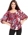 Alfani's pretty peasant top glows with a vibrant floral print and special details, like a pleated front placket.