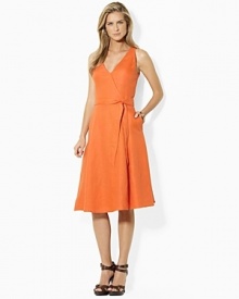Breezy linen is the foundation of a classic sleeveless dress with a chic V neckline and self-belt waist. Breezy linen is the foundation of a classic sleeveless dress with a chic V neckline and self-belt waist.
