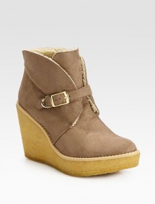 Casual faux suede essential with an adjustable buckle strap, mock shearling lining and elevated rubber wedge. Rubber heel, 3¾ (95mm)Rubber platform, 1¼ (30mm)Compares to a 2½ heel (65mm)Faux suede upperAdjustable buckle strapFaux shearling liningRubber solePadded insoleImported Casual faux suede essential with an adjustable buckle strap, mock shearling lining and elevated rubber wedge. Rubber heel, 3¾ (95mm)Rubber platform, 1¼ (30mm)Compares to a 2½ heel (65mm)Faux suede upperAdjustable buckle strapFaux shearling liningRubber solePadded insoleImported
