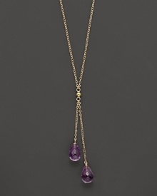 Twin amethyst briolettes sparkle from this 14K yellow gold lariat necklace. Twin amethyst briolettes sparkle from this 14K yellow gold lariat necklace.