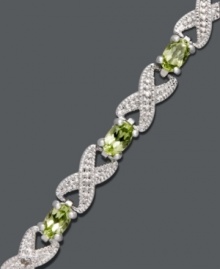 Seal it with a kiss. This exquisite bracelet by Victoria Townsend highlights glowing, oval-cut peridots (3-5/8 ct. t.w.) and diamond-accented X links. Crafted in sterling silver. Approximate length: 7 inches.