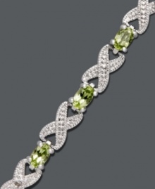 Seal it with a kiss. This exquisite bracelet by Victoria Townsend highlights glowing, oval-cut peridots (3-5/8 ct. t.w.) and diamond-accented X links. Crafted in sterling silver. Approximate length: 7 inches. Seal it with a kiss. This exquisite bracelet by Victoria Townsend highlights glowing, oval-cut peridots (3-5/8 ct. t.w.) and diamond-accented X links. Crafted in sterling silver. Approximate length: 7 inches.
