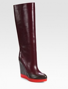 Commanding design of supple leather in rich seasonal hues, resting on a comfortable platform wedge. Rubber and leather-covered heel, 4½ (115mm)Rubber platform, 1 (25mm)Shaft, 14½Leg circumference, 14Leather upperPull-on styleLeather liningRubber solePadded insoleMade in Italy Commanding design of supple leather in rich seasonal hues, resting on a comfortable platform wedge. Rubber and leather-covered heel, 4½ (115mm)Rubber platform, 1 (25mm)Shaft, 14½Leg circumference, 14Leather upperPull-on styleLeather liningRubber solePadded insoleMade in Italy