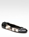 Sleek faux patent leather updates this classic Burberry check style. Leather/PVC upper Rubber sole Padded insole Made in ItalyOUR FIT MODEL RECOMMENDS ordering one half size up as this style runs small. 