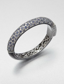 Half of this shimmering bangle is encrusted with gemstones in icy cool colors, the other half is finished in sleek enamel, and inside is lovely, lacy openwork.Blue sapphire, white topaz and blue topazEnamelBlack rhodium-plated sterling silverDiameter, about 2.2Hinged with push-lock claspImported Half of this shimmering bangle is encrusted with gemstones in icy cool colors, the other half is finished in sleek enamel, and inside is lovely, lacy openwork.Blue sapphire, white topaz and blue topazEnamelBlack rhodium-plated sterling silverDiameter, about 2.2Hinged with push-lock claspImported