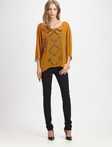 Lightweight, silk-like tunic with shimmering metallic accents, poncho sleeves and an open back. RoundneckThree-quarter poncho sleevesAsymmetrical hemOpen back with criss-cross tiesPolyesterDry cleanImportedModel shown is 5'9 (176cm) wearing US size Small. Lightweight, silk-like tunic with shimmering metallic accents, poncho sleeves and an open back. RoundneckThree-quarter poncho sleevesAsymmetrical hemOpen back with criss-cross tiesPolyesterDry cleanImportedModel shown is 5'9 (176cm) wearing US size Small.