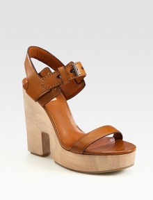 Sculpted wooden wedge with adjustable, burnished leather straps and a secure slingback strap. Wooden cutout wedge, 4¾ (120mm)Wooden platform, 1½ (40mm)Compares to a 3¼ heel (80mm)Leather upperLeather liningRubber solePadded insoleMade in ItalyOUR FIT MODEL RECOMMENDS ordering one half size up as this style runs small. Sculpted wooden wedge with adjustable, burnished leather straps and a secure slingback strap. Wooden cutout wedge, 4¾ (120mm)Wooden platform, 1½ (40mm)Compares to a 3¼ heel (80mm)Leather upperLeather liningRubber solePadded insoleMade in ItalyOUR FIT MODEL RECOMMENDS ordering one half size up as this style runs small.