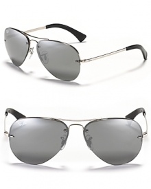 Timeless aviator sunglasses with a rimless frame and a rounded double bridge design. Timeless aviator sunglasses with a rimless frame and a rounded double bridge design.