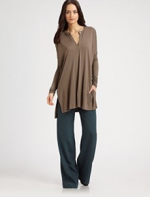 Lengthy tunic has a buttoned v-neck, long dolman sleeves and exaggerated hi-low hem. V-neck with button closureDropped shouldersLong dolman sleevesSide slits at hemHi-low hem hits below the hipsRayonDry cleanImportedModel shown is 5'10 (177cm) wearing US size Small. Lengthy tunic has a buttoned v-neck, long dolman sleeves and exaggerated hi-low hem. V-neck with button closureDropped shouldersLong dolman sleevesSide slits at hemHi-low hem hits below the hipsRayonDry cleanImportedModel shown is 5'10 (177cm) wearing US size Small.