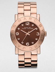 A warm rose goldtone ion-plated stainless steel timepiece with a boldly color dial and rhinestone markers. Quartz movementWater resistant to 5 ATMRound rose goldtone ion-plated stainless steel case, 36mm (1.4)Logo engraved bezelBrown dialRhinestone and numeric hour markersSecond hand Rose goldtone ion-plated stainless steel link braceletImported A warm rose goldtone ion-plated stainless steel timepiece with a boldly color dial and rhinestone markers. Quartz movementWater resistant to 5 ATMRound rose goldtone ion-plated stainless steel case, 36mm (1.4)Logo engraved bezelBrown dialRhinestone and numeric hour markersSecond hand Rose goldtone ion-plated stainless steel link braceletImported