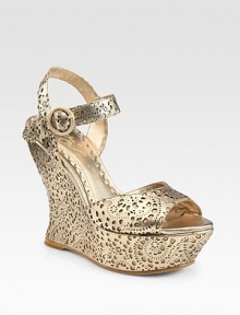 Shimmering metallic leather wedge with chic cutout detail and an adjustable ankle strap. Self-covered wedge, 5 (125mm)Covered platform, 1½ (40mm)Compares to a 3½ heel (90mm)Metallic leather upperLeather liningBuffed leather solePadded insoleImportedOUR FIT MODEL RECOMMENDS ordering one half size up as this style runs small. Shimmering metallic leather wedge with chic cutout detail and an adjustable ankle strap. Self-covered wedge, 5 (125mm)Covered platform, 1½ (40mm)Compares to a 3½ heel (90mm)Metallic leather upperLeather liningBuffed leather solePadded insoleImportedOUR FIT MODEL RECOMMENDS ordering one half size up as this style runs small.