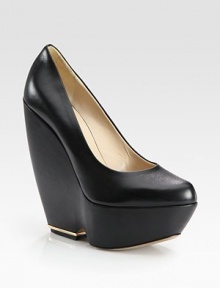 Lustrous leather with a sculpted, metal-plated wedge. Self-covered leather and metal wedge, 5¾ (145mm)Island platform, 1¾ (45mm)Compares to a 4 heel (100mm)Calf leather upperLeather lining and soleMade in ItalyOUR FIT MODEL RECOMMENDS ordering one size up as this style runs small. Lustrous leather with a sculpted, metal-plated wedge. Self-covered leather and metal wedge, 5¾ (145mm)Island platform, 1¾ (45mm)Compares to a 4 heel (100mm)Calf leather upperLeather lining and soleMade in ItalyOUR FIT MODEL RECOMMENDS ordering one size up as this style runs small.