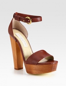 An adjustable ankle strap wraps around this chic faux leather design, resting on a tall wooden platform heel. Wooden heel, 5½ (140mm)Wooden platform, 1¼ (30mm)Compares to a 4¼ heel (110mm)Faux leather upperFaux leather liningRubber trek solePadded insoleMade in ItalyThis style runs large. We recommend ordering one half size down for a standard fit. 