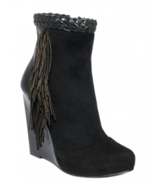 Indulge in the sexiest accents. Boutique 9's Cerys wedge booties feature a leather braid around the top and fringe detail on the sides. Indulge in the sexiest accents. Boutique 9's Cerys wedge booties feature a leather braid around the top and fringe detail on the sides.