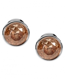 Smoky hues captivate the senses. Michael Kors' elegant stud earrings boast round-cut smoky topaz-colored cubic zirconia set in silver tone mixed metal. Approximate diameter: 1/2 inch. Smoky hues captivate the senses. Michael Kors' elegant stud earrings boast round-cut smoky topaz-colored cubic zirconia set in silver tone mixed metal. Approximate diameter: 1/2 inch.