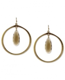 Topaz takes center stage on these hoop earrings from Jessica Simpson. The hoops are crafted from gold tone mixed metal. Approximate drop: 3 inches. Topaz takes center stage on these hoop earrings from Jessica Simpson. The hoops are crafted from gold tone mixed metal. Approximate drop: 3 inches.