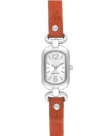 Add an unexpected splash of color with this refined watch from by Nine West. Watch crafted of orange leather strap and oval silver tone mixed metal case. Silver tone dial features tonal applied stick indices, numerals at twelve and six o'clock, silver tone hour and minute hands, sweeping second hand and logo at six o'clock. Quartz movement. Limited lifetime warranty.