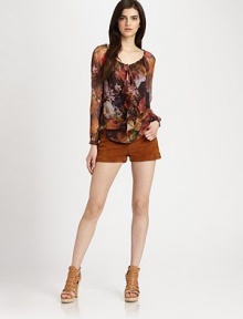 Rendered in a rich floral print, this semi-sheer silk blouse has a drawstring scoopneck, ruffle front and length that hits below the hips. Drawstring scoopneck with ruffle detailLong bishop sleeves with buttoned cuffsLonger length hits below the hipsSilkDry cleanImportedModel shown is 5'10 (177cm) wearing US size Small. Rendered in a rich floral print, this semi-sheer silk blouse has a drawstring scoopneck, ruffle front and length that hits below the hips. Drawstring scoopneck with ruffle detailLong bishop sleeves with buttoned cuffsLonger length hits below the hipsSilkDry cleanImportedModel shown is 5'10 (177cm) wearing US size Small.