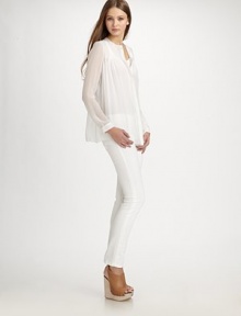 Semi-sheer silk v-neck with a hidden button front and long silhouette that hits below the hips. V-neckLong sleevesButtoned cuffsHidden button frontLonger length hits below the hipsSilkDry cleanImportedModel shown is 5'11 (180cm) wearing US size Small. Semi-sheer silk v-neck with a hidden button front and long silhouette that hits below the hips. V-neckLong sleevesButtoned cuffsHidden button frontLonger length hits below the hipsSilkDry cleanImportedModel shown is 5'11 (180cm) wearing US size Small.