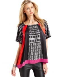 A graphic print with bright blocks of color gives this Vince Camuto top stop-them-in-their-tracks style. Wear with dark denim or go for all out glam with faux-leather leggings. A graphic print with bright blocks of color gives this Vince Camuto top stop-them-in-their-tracks style. Wear with dark denim or go for all out glam with faux-leather leggings.