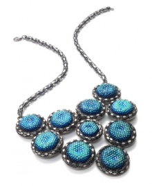 Go for glitter and perfect your party look. This festive bib necklace boasts rows of blue plastic cabochon stones with a glittery finish. Crafted in hematite tone mixed metal. Approximate length: 18 inches + 2-inch extender. Approximate drop: 3 inches. Go for glitter and perfect your party look. This festive bib necklace boasts rows of blue plastic cabochon stones with a glittery finish. Crafted in hematite tone mixed metal. Approximate length: 18 inches + 2-inch extender. Approximate drop: 3 inches.