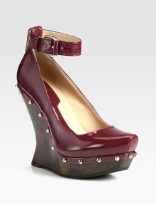 A sculptural wooden heel lifts this studded patent leather design, topped with a trendy-worthy ankle strap. Wooden wedge, 5 (125mm)Wooden platform, 1 (25mm)Compares to a 4 heel (100mm)Patent leather upper with metal studsAdjustable ankle strapLeather liningRubber solePadded insoleImportedOUR FIT MODEL RECOMMENDS ordering one half size up as this style runs small. A sculptural wooden heel lifts this studded patent leather design, topped with a trendy-worthy ankle strap. Wooden wedge, 5 (125mm)Wooden platform, 1 (25mm)Compares to a 4 heel (100mm)Patent leather upper with metal studsAdjustable ankle strapLeather liningRubber solePadded insoleImportedOUR FIT MODEL RECOMMENDS ordering one half size up as this style runs small.