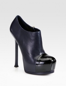 Sleek leather ankle boot with a hidden platform, towering heel and shiny patent cap toe. Self-covered heel, 4¼ (110mm)Hidden platform, 1¼ (30mm)Compares to a 3 heel (75mm)Leather upper with a patent leather cap toeSide zipLeather lining and solePadded insoleMade in Italy Sleek leather ankle boot with a hidden platform, towering heel and shiny patent cap toe. Self-covered heel, 4¼ (110mm)Hidden platform, 1¼ (30mm)Compares to a 3 heel (75mm)Leather upper with a patent leather cap toeSide zipLeather lining and solePadded insoleMade in Italy