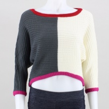 Cozy on up when it's cold out with this colorblocked sweater. This women's top features a boat neckline, 3/4 sleeves and a cropped high-low hemline. 100% acrylic. Machine wash. Imported.